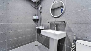 A modern bathroom with a white sink, a mirror, and a shower. - Gimcheon Sweet Hotel (Gimcheon)