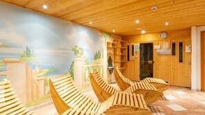 A wooden interior with a mural of a landscape, wooden benches, and a reception area with a clock and signs. - Apartment Near the Centre and ski Resort (Gaschurn)