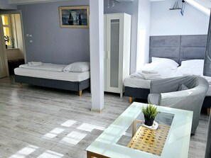 Cozy retreat with a large bed and a smaller companion bed, featuring a stylish headboard and comfortable bedding.