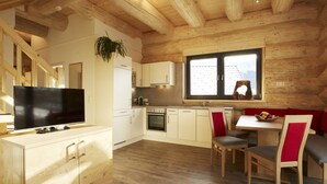 Una cocina moderna con armarios de madera, horno integrado y un ventanal amplio.