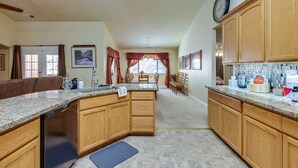 A spacious kitchen with wooden cabinets, granite countertops, and a central island. - Groveland Vacation Rental Near Pine Mountain Lake! (Groveland)