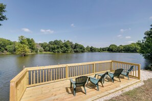 A wooden deck with chairs overlooking a lake. - Lakefront College Station Home Near Texas A & M! (College Station)