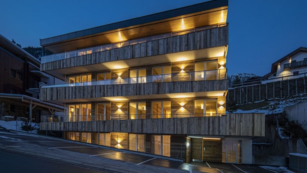 A multi-story wooden building with balconies, large windows, and a covered entrance. - Alpine Myth (Sankt Anton am Arlberg)