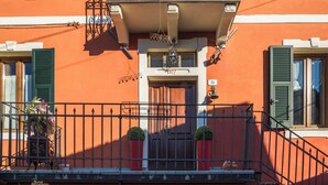 A building with a balcony, a door, and a window with shutters. - Orazio Liberty House, Lunigiana, Nature (Fivizzano)