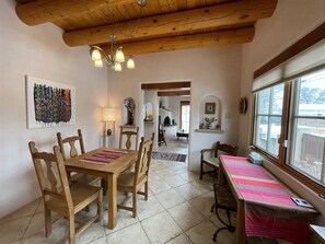 A dining area with wooden furniture and a chandelier.