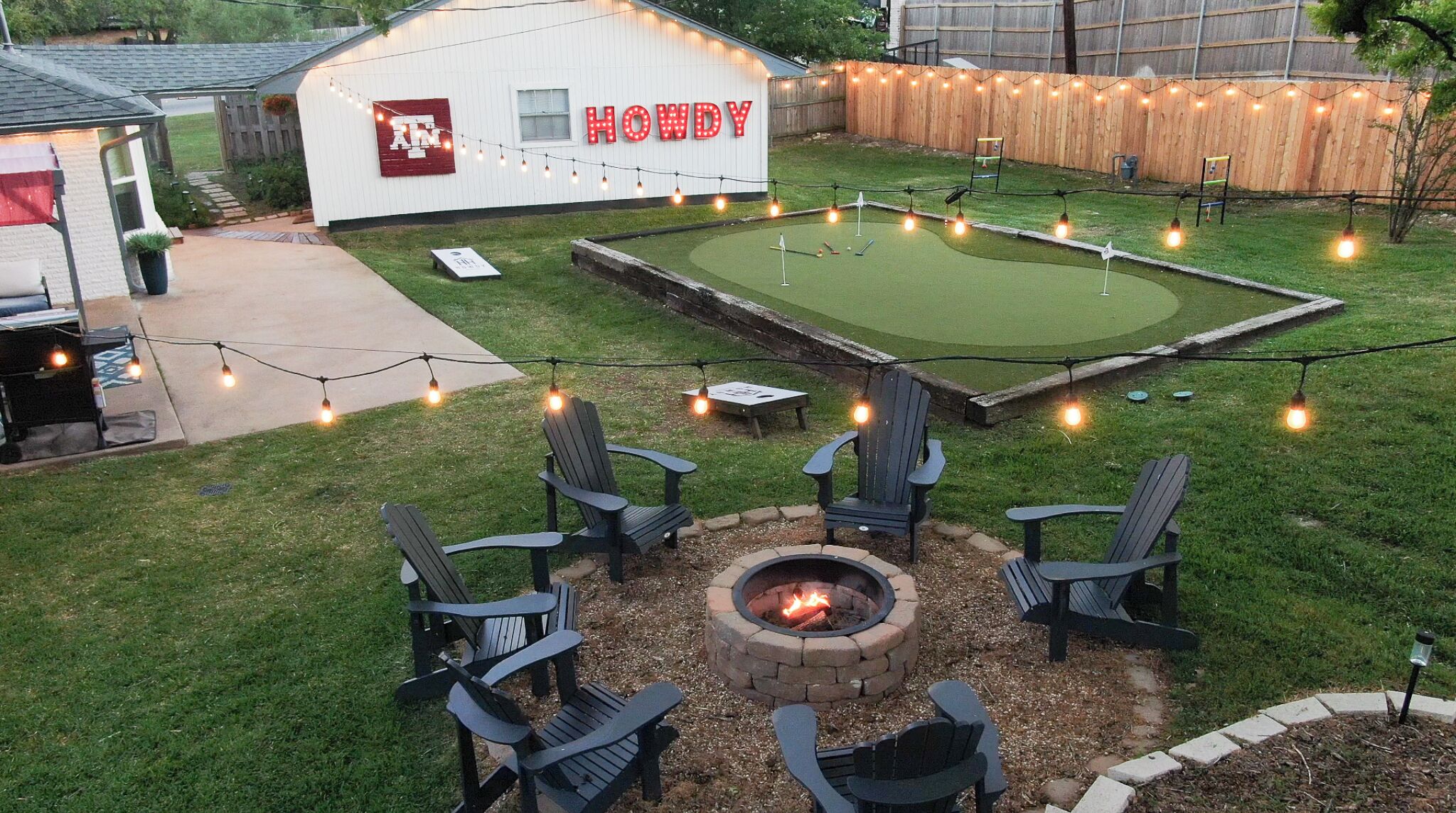 This is the backyard moment everyone's been waiting for. Fire pit crackling, putting green ready, string lights glowing.