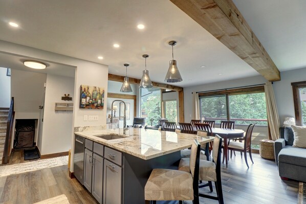 Enjoy cooking in the well-lit kitchen with a large island and stainless steel appliances.