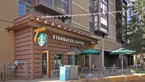 A Starbucks Coffee with outdoor seating and a sign indicating a daily summer special. - Mp613h Mountain Plaza Hotel Room 1 Bedroom Hotel Room (Copper Mountain)