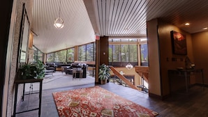 A spacious living area with a large window, a wooden ceiling, and a staircase leading to an upper level. - Mp613h Mountain Plaza Hotel Room 1 Bedroom Hotel Room (Copper Mountain)