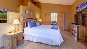 A bedroom with a large bed, a wooden dresser, a television, and a painting on the wall. - 334 Willow Lake Ct. 4br W/loft 3ba 4 Bedroom Townhouse (Silverthorne)