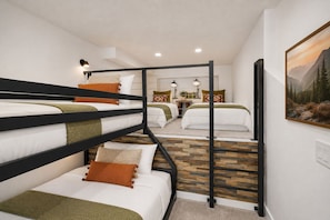 A bunk bed room with a wooden floor, a painting on the wall, and a small table with books. - 1674 Captain Molly's Hideout! Walk To Slopes! Hottub Pool! 3 Bedroom Condo (Park City)