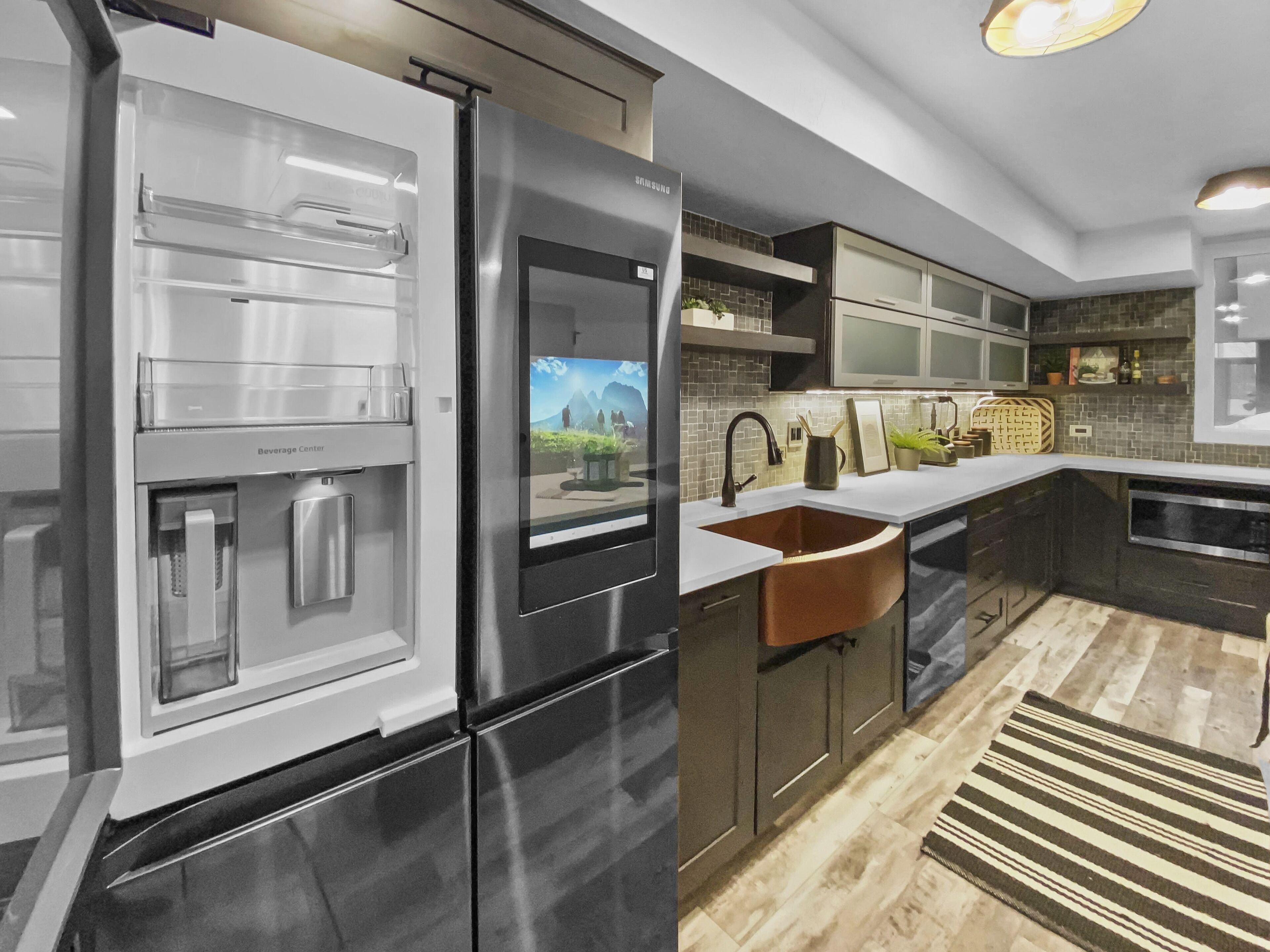 A modern kitchen with stainless steel appliances, a built-in sink, and a large island.