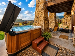 A hot tub with a wooden exterior, a stone pillar, and a view of the surrounding landscape. - 4202 Modern Vibe At Fairway Springs 3 Bedroom Home (Park City)