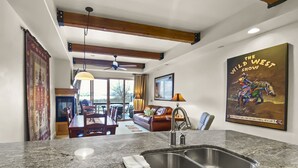 A modern kitchen with granite countertops, a double sink, and wooden cabinets.