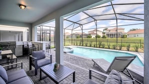 A covered outdoor area with a pool, seating, and a grill. - 3967lana 7 Bedroom Divers (Davenport)