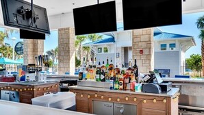 A bar area with multiple liquor bottles, a cash register, and a flat-screen TV mounted above. - Ultimate 5 Bedroom Windsor Island Resort 3966Lana 5 Villa (Davenport)