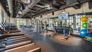 A gym with treadmills, weight machines, and exercise balls. - Florida Garden Luxury Home With Private Pool & Spa 6 Bedroom Villa (Kissimmee)