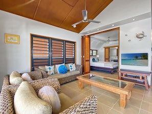 A spacious living area with a sofa, coffee table, and a television.