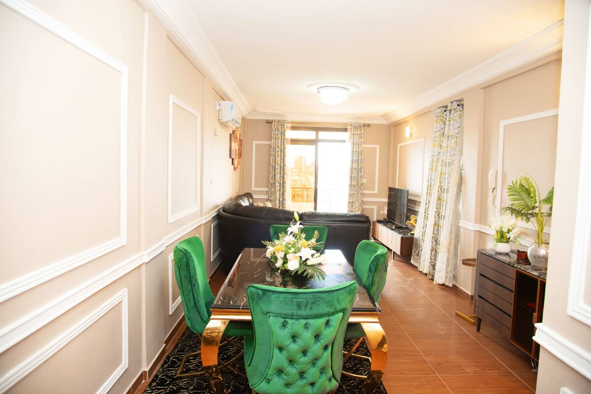 A dining area with a table, chairs, and a sofa.