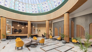 A spacious lobby with a high ceiling, a reception desk, and multiple seating areas. - Hurghada Long Beach Resort (Hurghada)