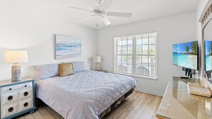 A bedroom with a bed, a ceiling fan, a TV, and a window with blinds. - Bubba's Beach Blessing - 4BR/2BA- Pet Friendly (North Myrtle Beach)
