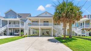 A beachfront property with multiple balconies, a covered entrance, and a clear view of the ocean. - Bubba's Beach Blessing - 4BR/2BA- Pet Friendly (North Myrtle Beach)
