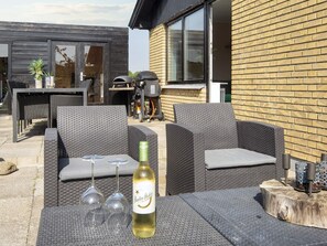 Relax in the outdoor seating area with a comfortable sofa set and enjoy a glass of wine.