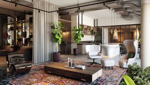 Ein modernes Wohnzimmer mit einer Couch, Sesseln, einem Couchtisch und einem gemusterten Teppich.