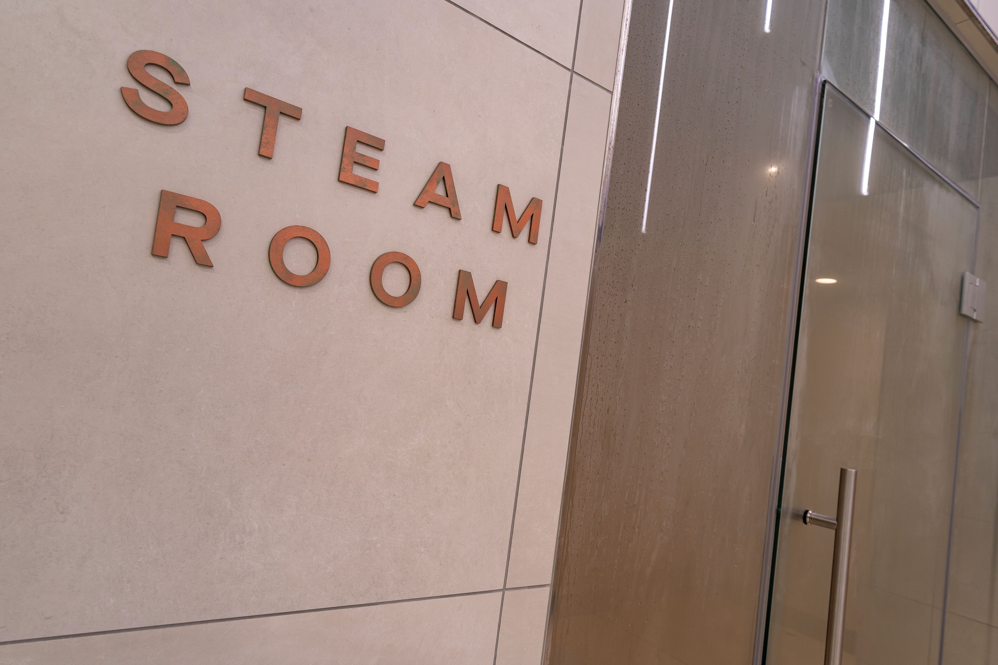 A wall with the words "STEAM ROOM" in large letters.