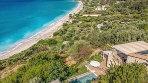 A coastal property with a private pool, a beach, and lush greenery. - Villa Kalou Cottage by Villa Plus (Ionian Islands)