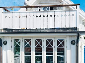 A white building with a balcony and large windows. - 4 Star Holiday Home in Kyrkesund (Kyrkesund)