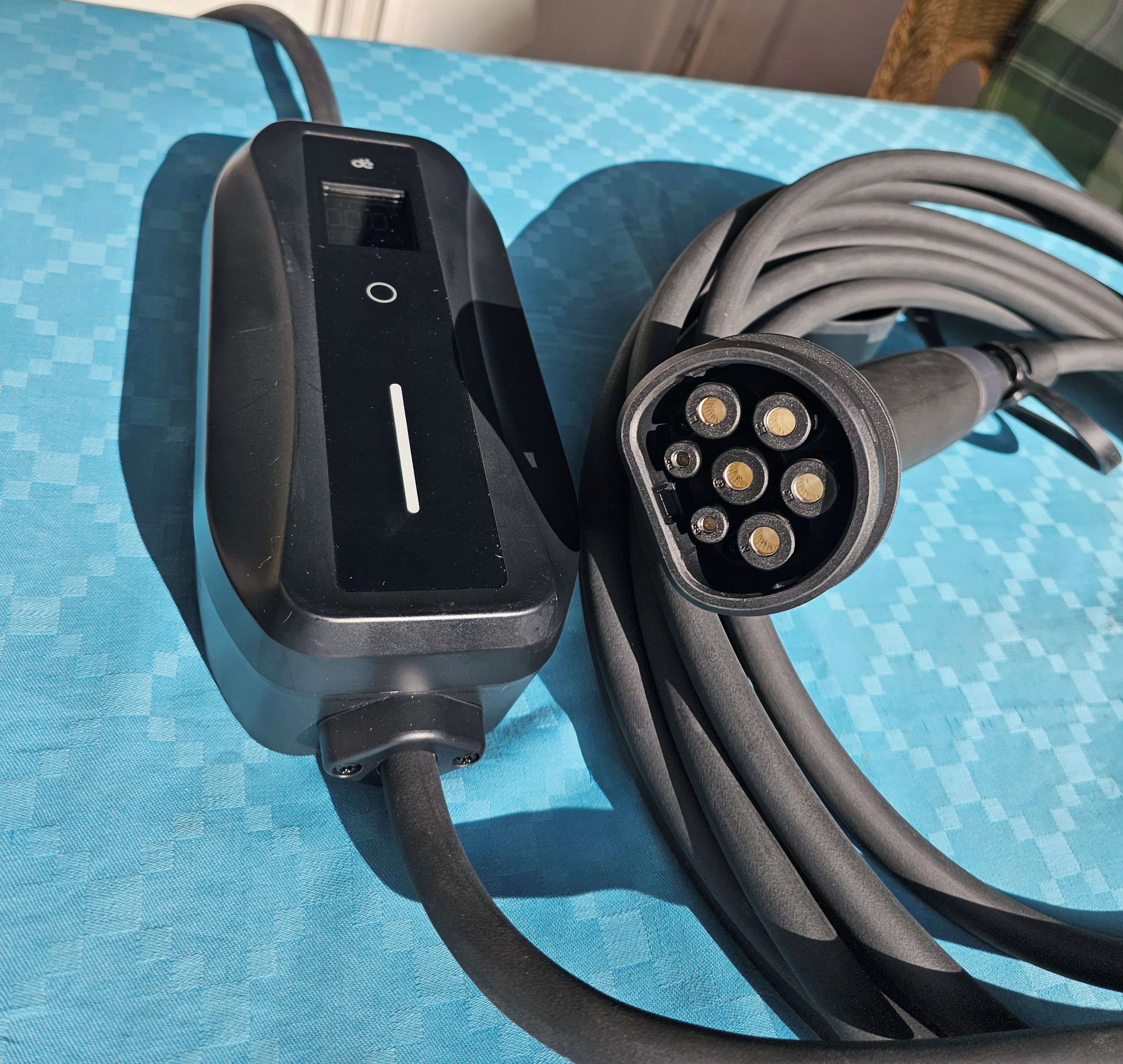A black charging cable with a USB port and a power adapter connected to it.