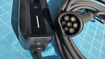 A black charging cable with a USB port and a power adapter connected to it.
