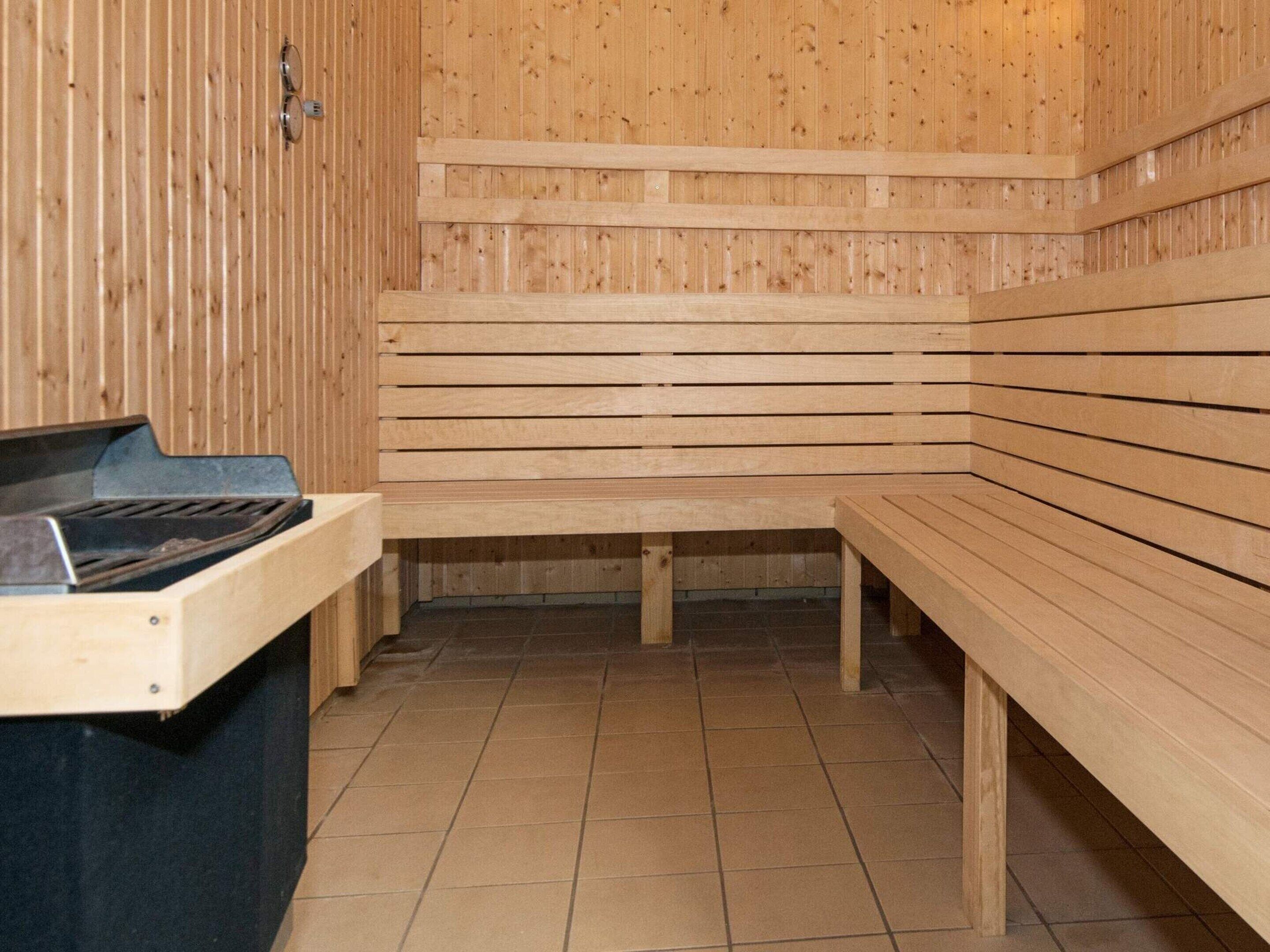 A sauna with wooden benches and a sauna table.
