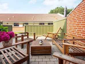 A patio area with wooden furniture, a table, and a bench. - 6 Person Holiday Park Home in Hemmet (Hemmet)