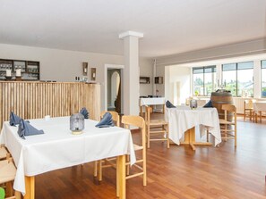Enjoy a casual dining experience in our inviting space, featuring comfortable seating and elegant table settings.