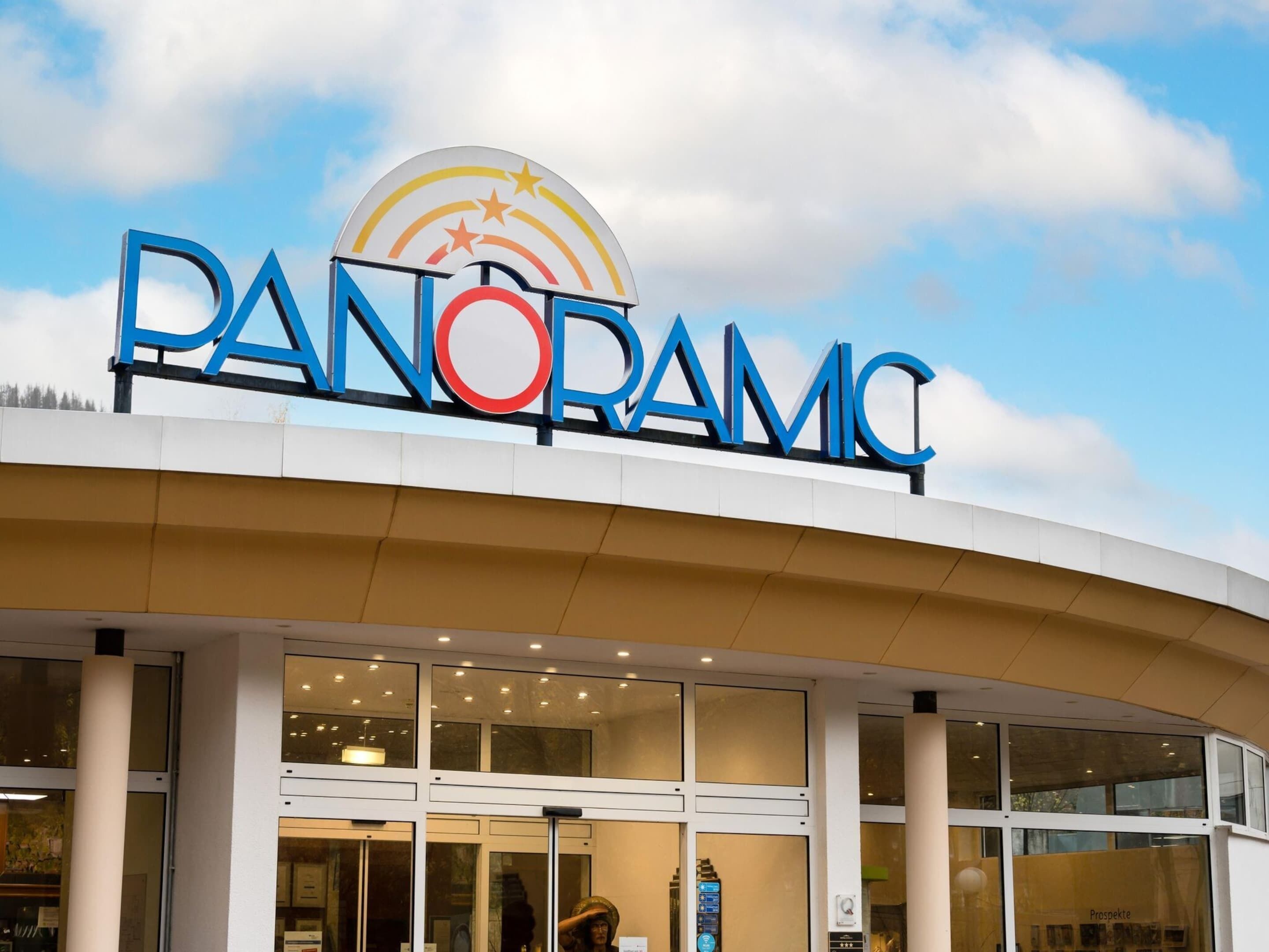 The exterior of a building with a large sign reading "PANORAMIC."