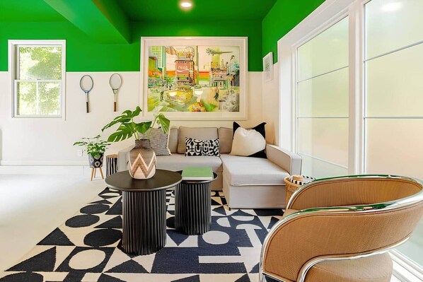 A modern living room with a sofa, coffee table, and decorative items.