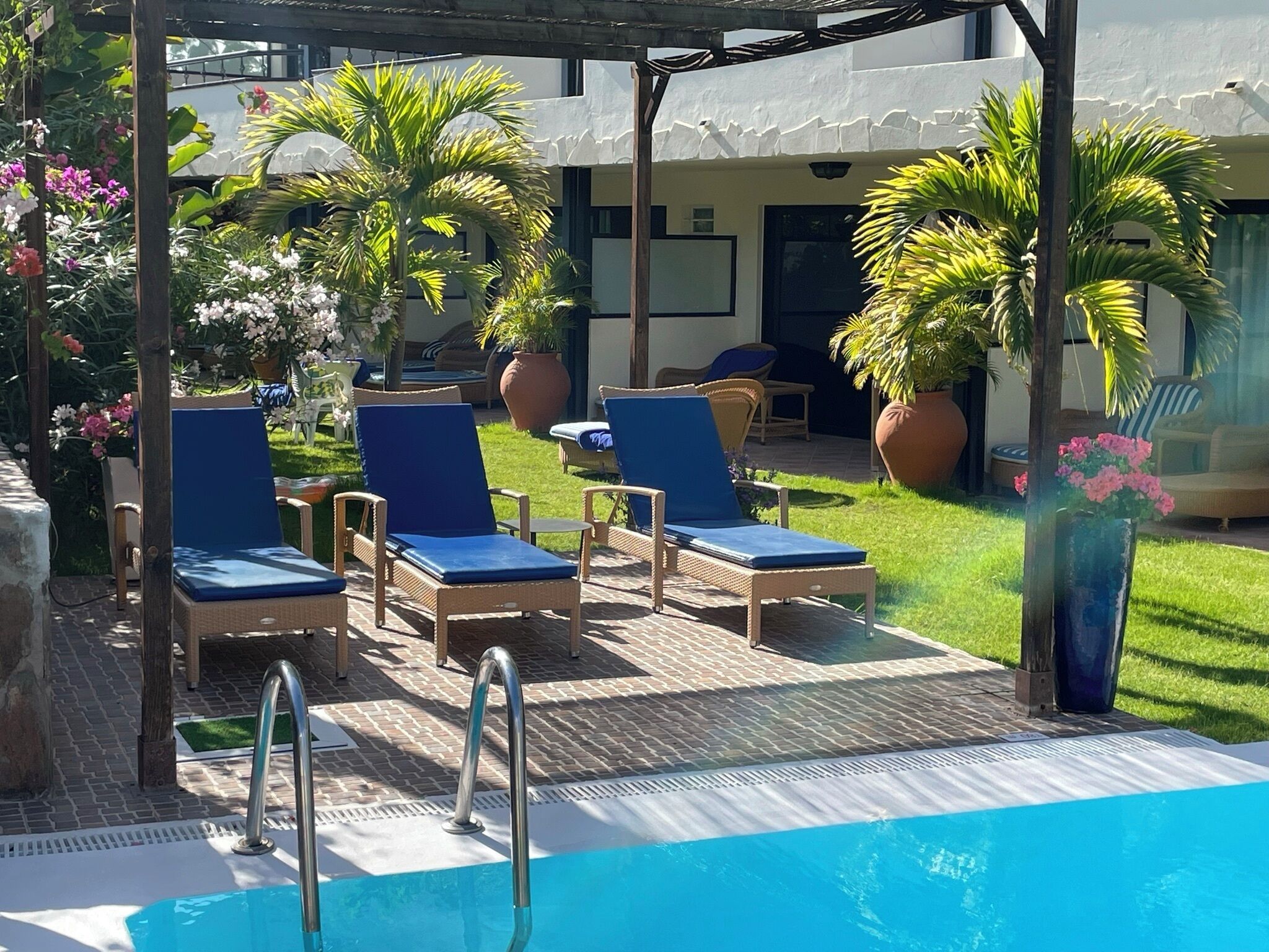 A poolside area with lounge chairs and a pool.