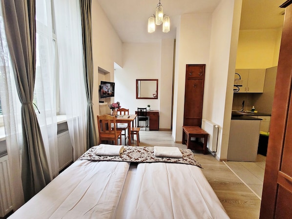 Classic Studio Suite, Courtyard View | In-room safe, desk, laptop workspace, iron/ironing board