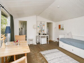 A room with a bed, a desk, a chair, a table, and a window. - 10 Person Holiday Home in Graested (Graested)