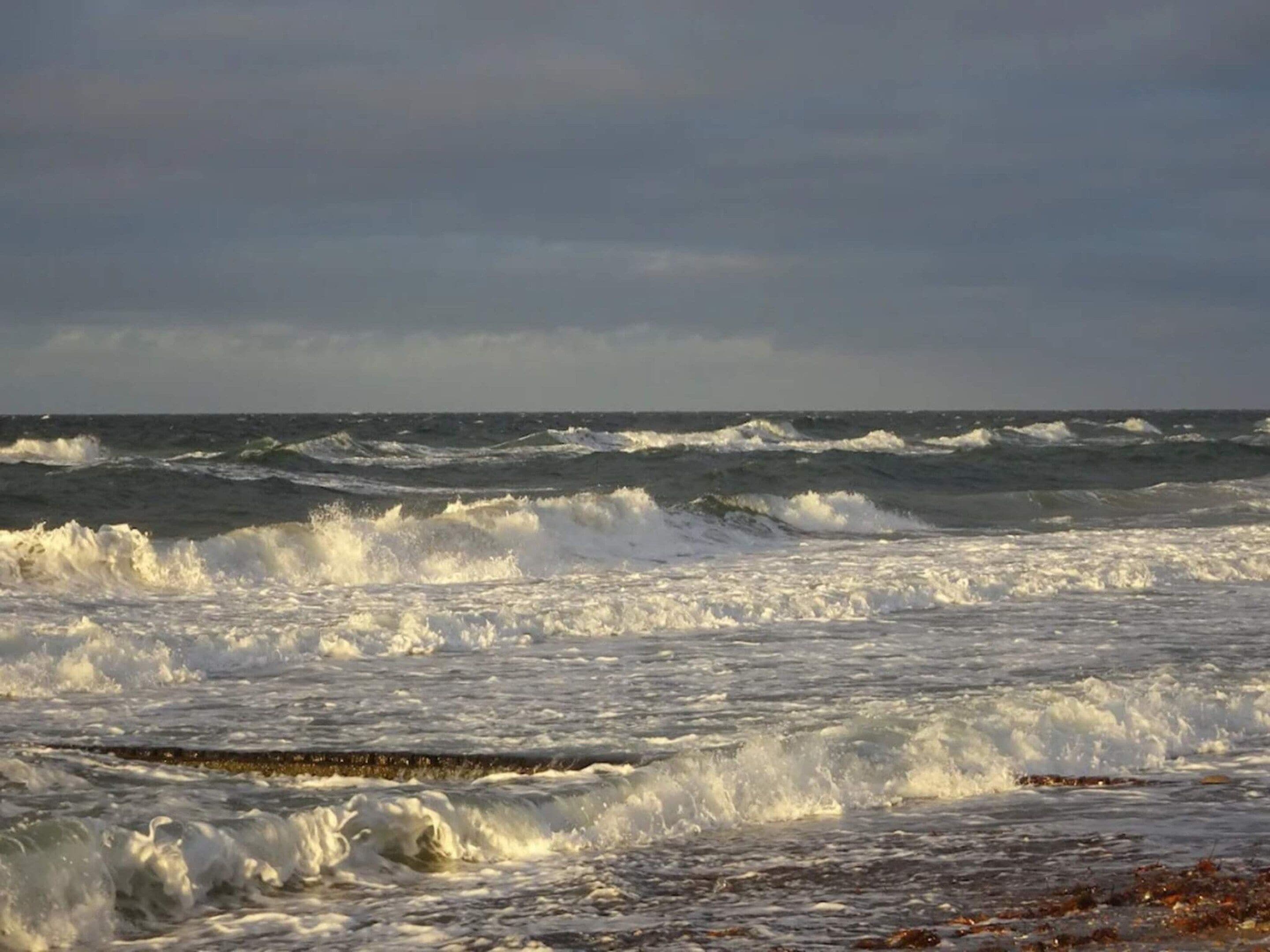 A beach with waves crashing onto the shore.