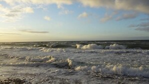 A beach with waves and a partly cloudy sky. - 10 Person Holiday Home in Graested (Graested)