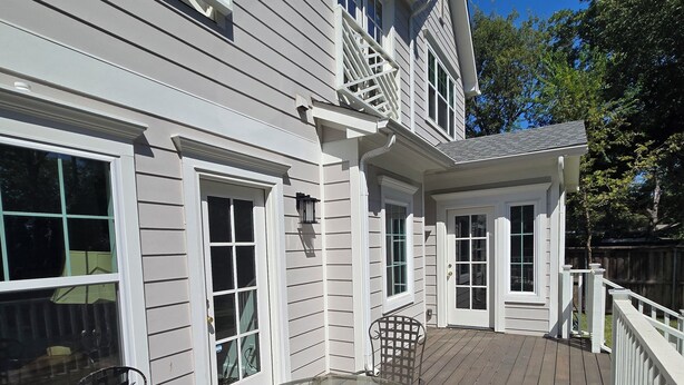 A deck with a glass-top table and chairs, surrounded by white railings and a wooden deck. - NEW! Gorgeous 4-bedroom in quiet,  upscale  neighborhood near White Rock Lake, (Dallas)