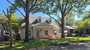 A two-story house with a front porch, a garage, and a well-maintained lawn. - NEW! Gorgeous 4-bedroom in quiet,  upscale  neighborhood near White Rock Lake, (Dallas)