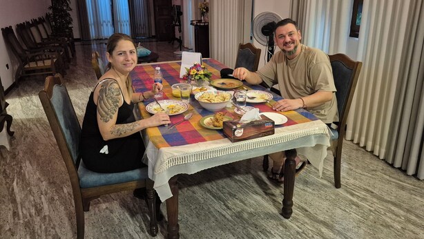 A dining room with a table set for two, featuring a variety of dishes and drinks. - Elegant family friendly villa close to airport & beach (Pamunugama)