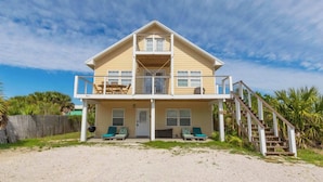 A two-story beach house with a balcony, a covered patio, and a staircase leading to the upper level. - Sel De Vie A 4 Bedrooms Sleeps 10 (Gulf Shores)