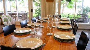 A dining table set for a meal with plates, glasses, and cutlery.