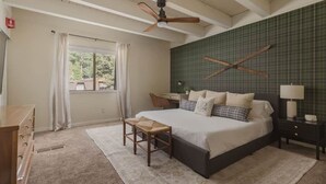 A bedroom with a bed, a desk, a chair, a nightstand, and a ceiling fan. - The Incline Cabin, Hot Tub | Fireplace | Arcade | 5min to Diamond Pk (Incline Village)
