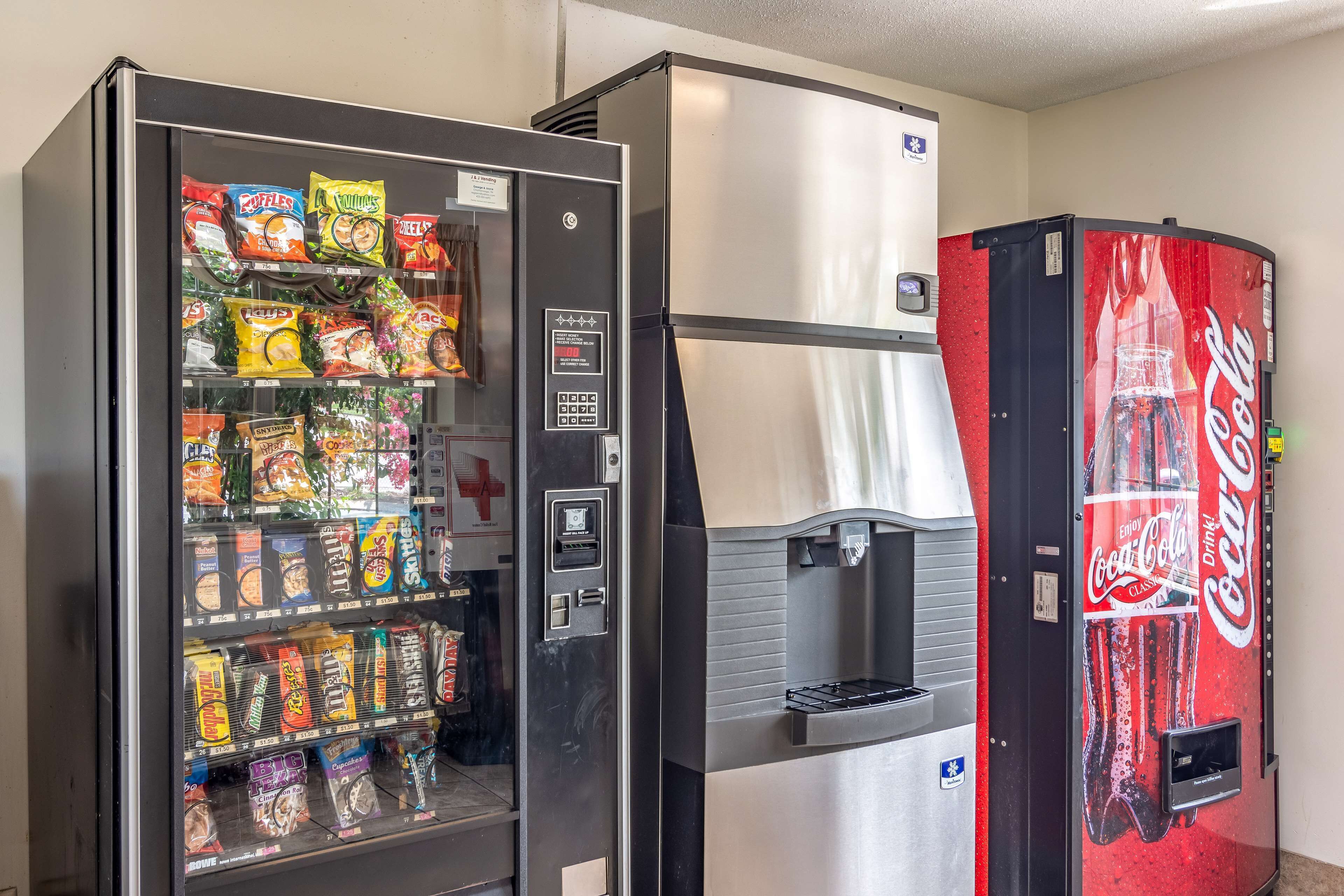 A vending machine with snacks and a Coca-Cola dispenser.